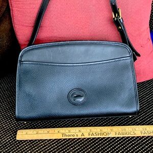 Authentic Dooney & Bourke  shoulder bag with straps long enough to cross body.